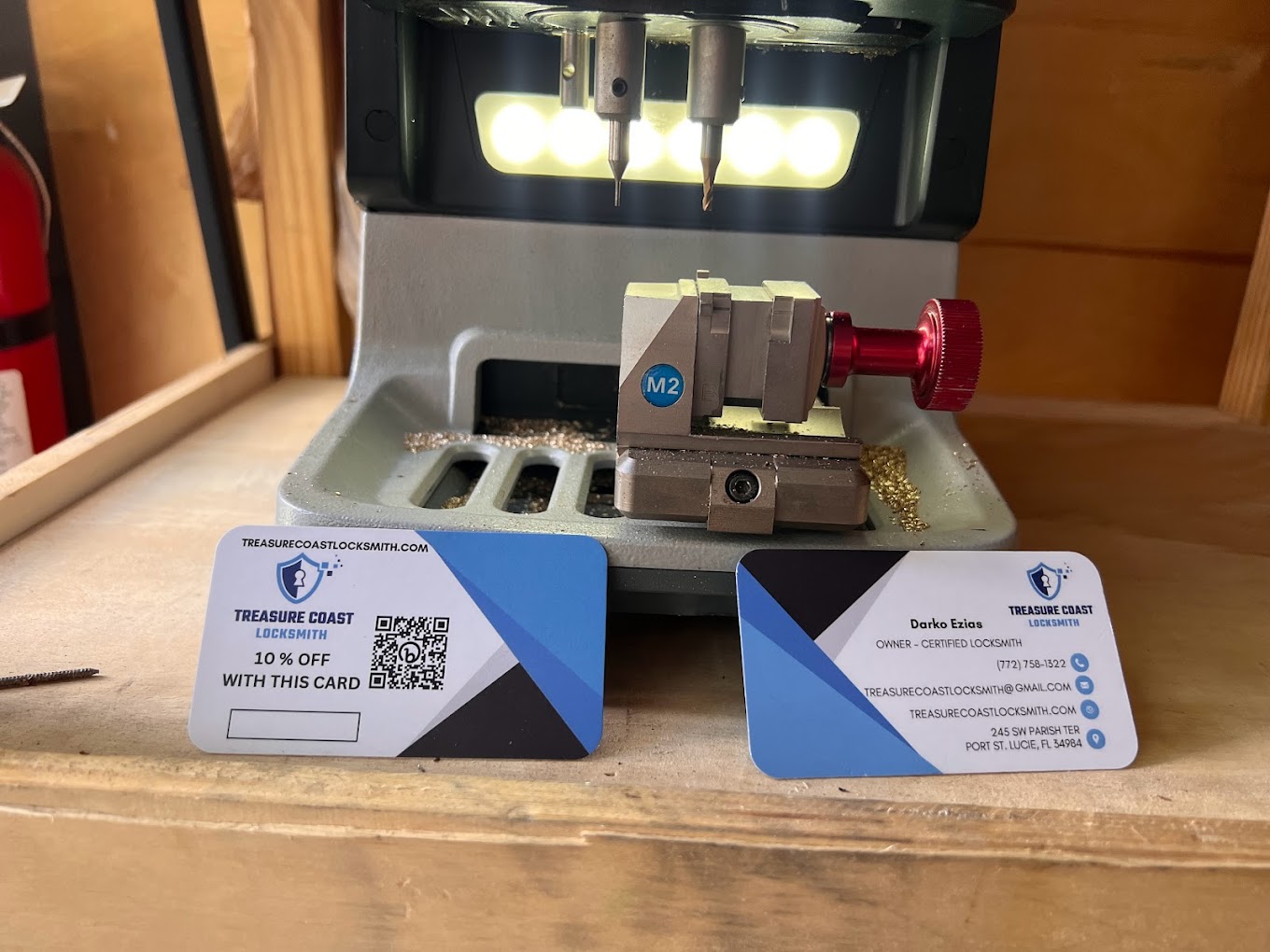 Treasure Coast Locksmith key-cutting machine with Florida-licensed business cards